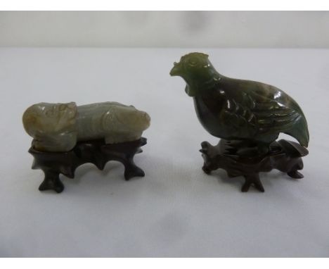A Chinese jade carving of a dragon on hardwood stand and a green hardstone carving of a bird on hardwood stand, A/F