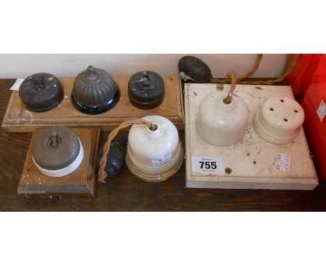 A quantity of old electrical fitting items including brass fronted and Bakelite light switches, ceramic ceiling bosses, etc.