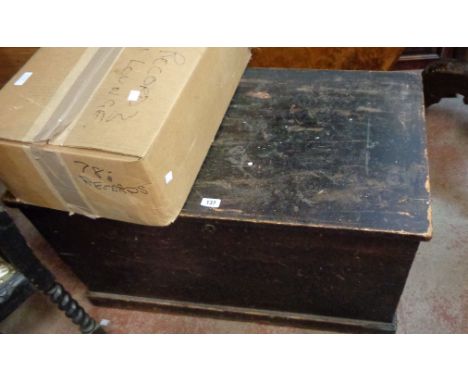 A 91cm Victorian stained pine lift-top trunk (candle box missing) with flanking iron drop handles
