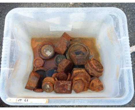A plastic crate containing old scales weights