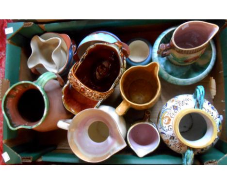 A box containing assorted ceramic items including majollica jugs, Torquay pottery, etc.
