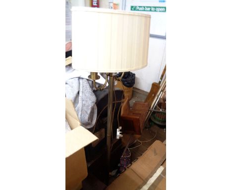 A heavy brass twin light standard lamp with reeded pillar, circular base and shades
