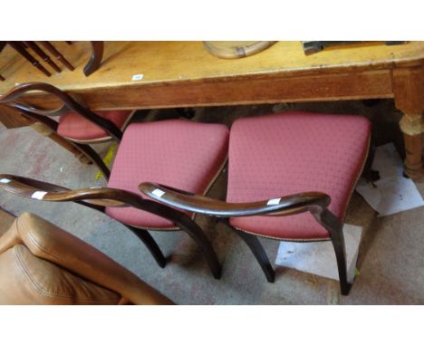 A set of six Victorian rosewood framed balloon back dining chairs with red machine tapestry upholstery, set on cabriole front