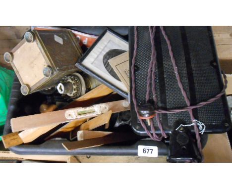 A crate containing assorted collectable items including old Bakelite hot water bottle, rug making tools, metalware, etc.