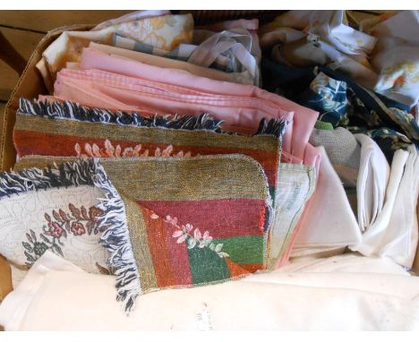 A box containing a quantity of textiles including tablecloths, etc.