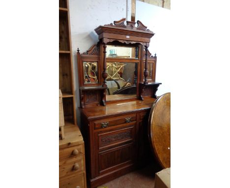 A 1.36m Edwardian walnut mirror back sideboard with bevelled plates and flanking shelves over two short drawers and pair of p