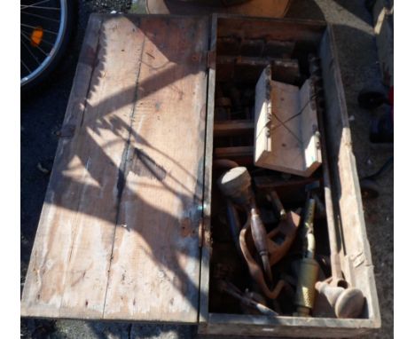 A wooden box containing assorted tools including planes, moulding planes, braces, etc.