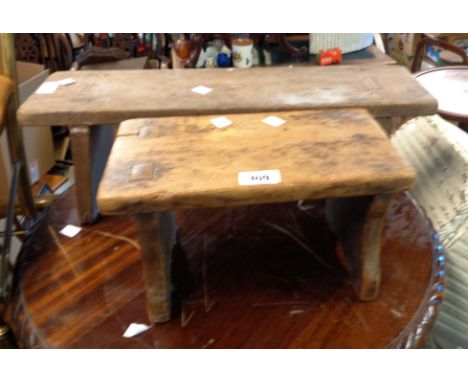 A small old rustic pine stool, set on shaped standard ends - sold with another rustic stool and an Edwardian mahogany book tr