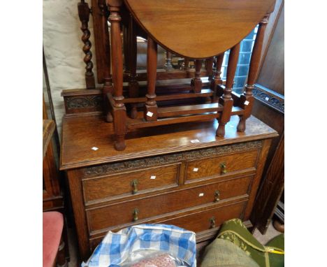 A 1.06m early 20th Century oak dressing chest with oblong bevelled swing mirror and barley twist supports over two short and 