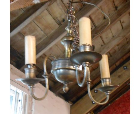 An old brass electric ceiling lamp of three branch candelabra form