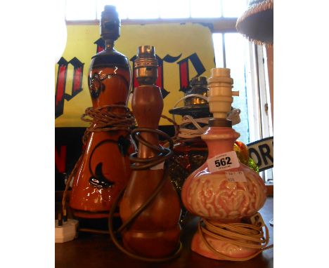 Four assorted table lamps comprising French pottery, converted Victorian glass oil lamp, turned wood example and converted ar
