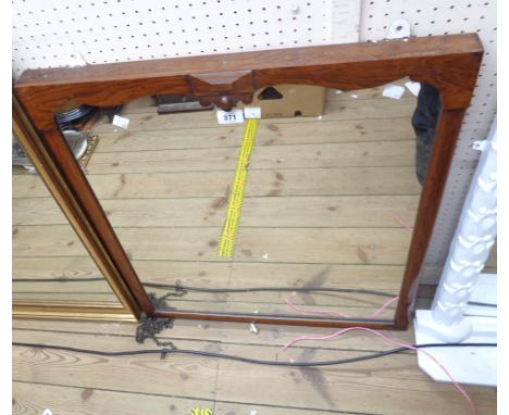 An antique rosewood framed wall mirror with shaped frame top and later oblong plate
