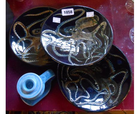 Three sgraffito and slip plates decorated with octopuses - sold with a 1930's Art Deco pottery candlestick