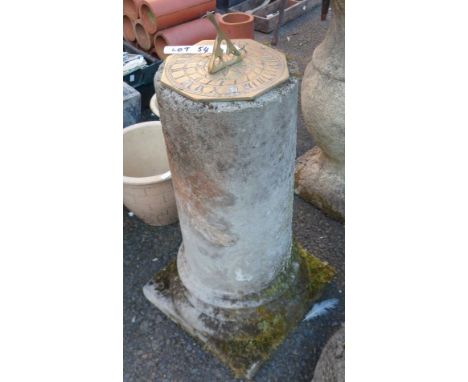 A concrete pedestal with brass sundial top