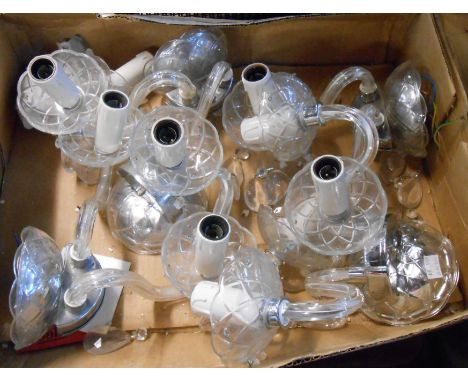 A box containing five decorative glass and chrome two branch wall candelabra, each with lustre drops