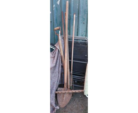 A collection of antique and later garden tools including Devon shovel, rake, fork, etc.