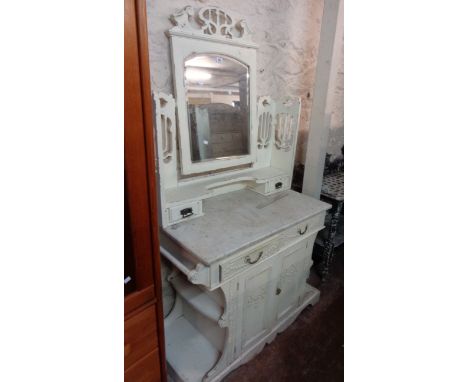 A 1.07m late Victorian white painted marble topped washstand with swing mirror, flanking shelves and drawers over two frieze 