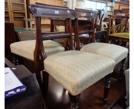 Three matching late Regency mahogany framed dining chairs with modern upholstery to seats, set on ring turned front legs