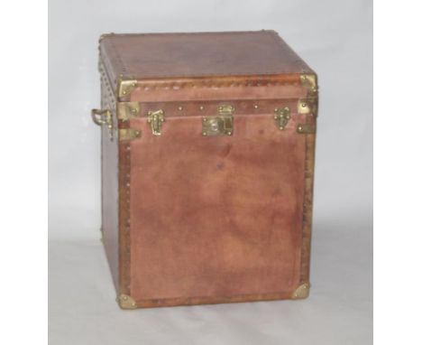 A reproduction leatherette storage trunk, with brass finish, 60cm high, 49cm wide, 49cm deep.