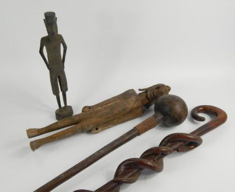 Tribal Art. Three items to include a male figure, a knobkerri with iron band and a walking stick carved with intertwined serp