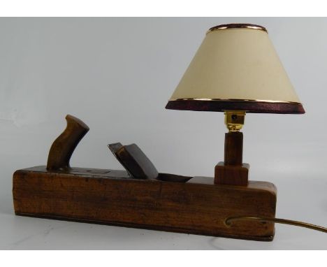 An oak moulding plane, converted to a table lamp, 43cm long.