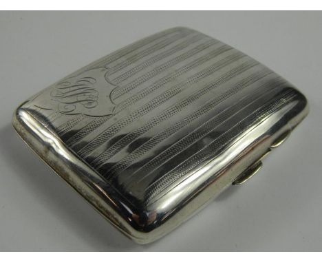 A George V silver cigarette case, with engine turned reeded design and shield crest bearing the initials 'JWL', Chester 1913,