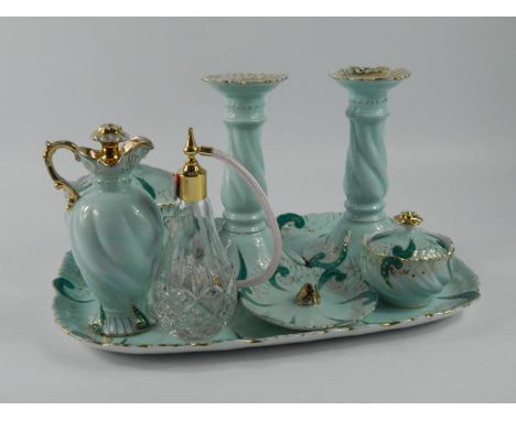 An early 20thC dressing table set, decorated on turquoise ground and picked out in gilt, comprising of a tray, two candlestic