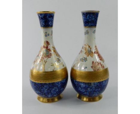 A pair of late 19th/early 20thC Wedgwood bottle shaped vases, each decorated with flowers in imari colours within blue printe