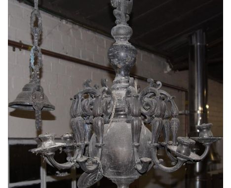 A heavy ten branch chandelier light fitting, of patinated white metal composition, and with bulbous baluster stem and scroll 