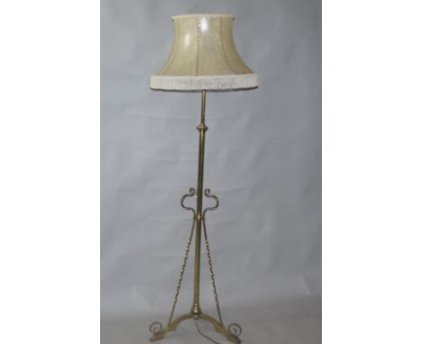 A Victorian brass standard lamp, with barley twist three reed tripod base, and later shade, the lap 147cm high.