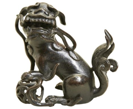 A SMALL BRONZE BUDDHIST LION LATE MING DYNASTY possibly a finial from a larger item 9cm high  PROVENANCE: From a Private Wilt