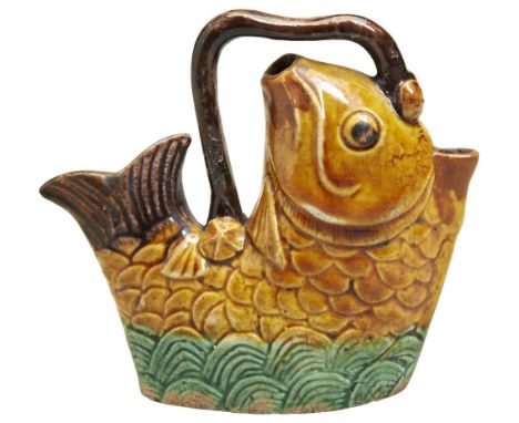 A FAMILLE VERTE BISCUIT PORCELAIN WATER-DROPPER KANGXI PERIOD (1662-1722) modelled in the form of a fish above waves. 8cm hig
