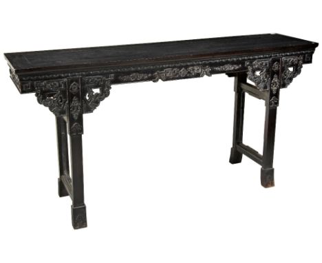 A CHINESE CARVED HARDWOOD ALTAR TABLE 20TH CENTURY the rectangular floating panel top above an elaborate dragon & scroll carv