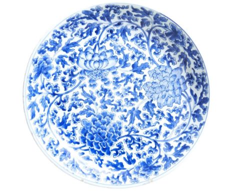 A LARGE BLUE &amp; WHITE 'PEONY' DISH KANGXI PERIOD (1662-1722) painted throughout in underglaze blue with peony blooms and s
