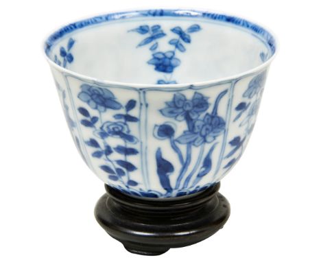 SMALL BLUE AND WHITE WINE CUP KANGXI PERIOD (1662-1722) painted with panel of blossoming leafy stems, with wooden stand and s