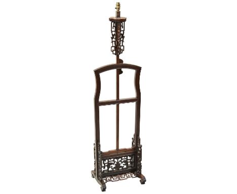 A CHINESE HARDWOOD LANTERN STAND LATE QING DYNASTY with openwork carved frame and adjustable platform; electrified 127cm high