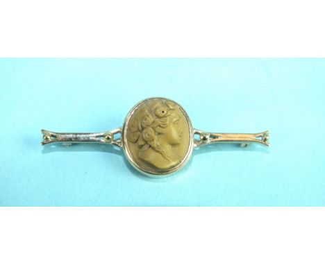 A lava cameo bar brooch of a portrait of a lady with flowers in her hair, on unmarked gold mount, 5.2cm, 5.1g, (damage to nos