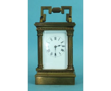 A miniature brass carriage clock, the pillar and corniced case with rectangular enamelled dial, 11cm high, (over-wound).