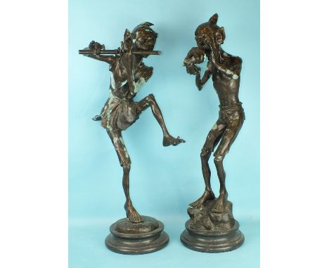 A bronzed metal figure of a pixie playing a flute, on marble base, 86cm high and another blowing a conch shell, 85cm high, pa