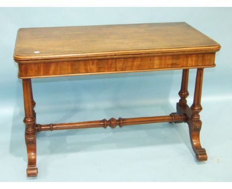 A late-19th century large mahogany card table, the fold-over top with moulded edge swivelling to reveal a compartment, raised