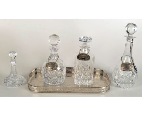 Four cut glass decanters and stoppers, with three silver plated labels entitled Scotch, Sherry and Brandy, largest height 32c