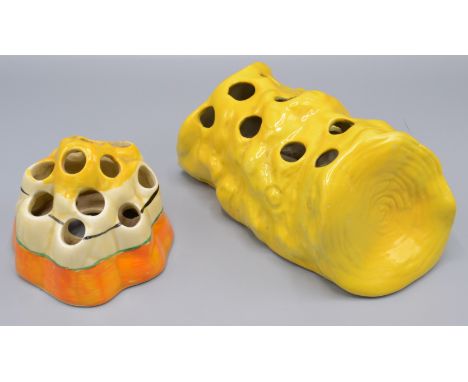 A Clarice Cliff Fantasque posy holder, diameter 8cm and a yellow ground Bizarre posy holder, length 14.5cm.