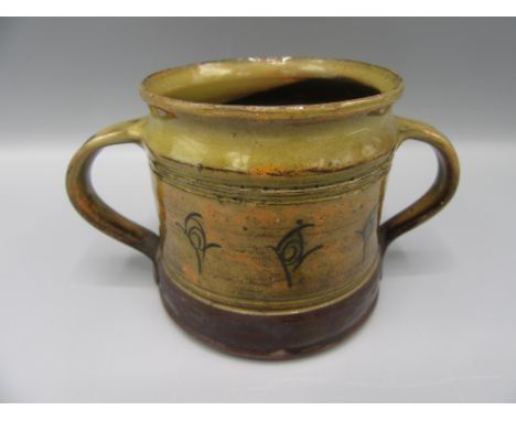 A Michael Cardew Winchcombe Pottery twin handled mug, 1930s to 1960s, decorated with stylised flowers, height 7.5cm   Conditi