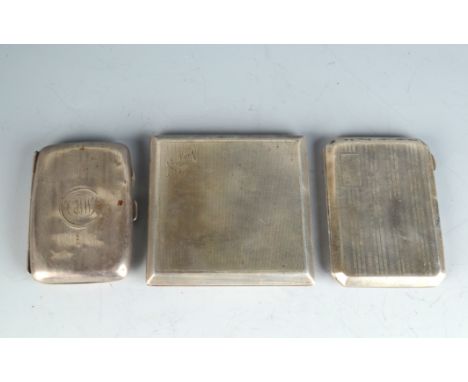 Three engine turned silver cigarette cases. 7.7oz.