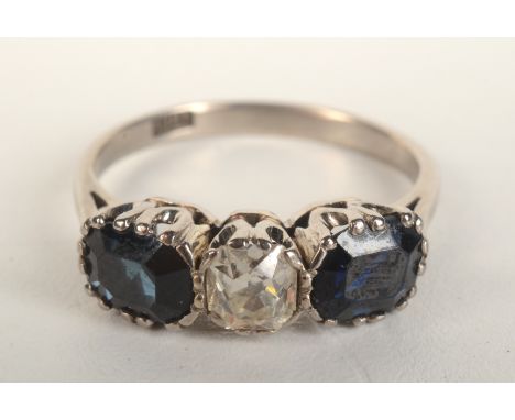 An 18ct white gold ring set a central diamond flanked by sapphires. 