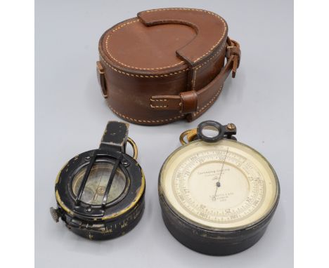 A Surveying Aneroid Compensated Barometer, by E.R. Watts & Son, London 2891', in a leather case, diameter 8cm and a prismatic