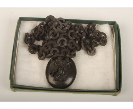 A black late Victorian locket on black ring link chain. 