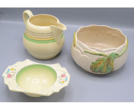A Clarice Cliff planter, decorated with leaves, diameter 17.5cm, a Clarice Cliff bowl and jug. 