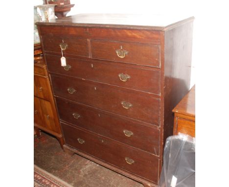 An oak chest of drawers, 19th century, the rectangular moulded top above a mahogany frieze, two short and four long graduated