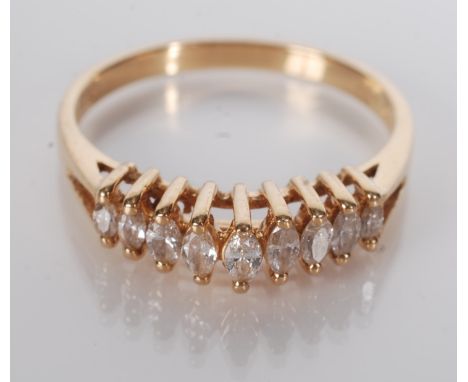 An 18ct gold contemporary ring set with a row of nine graduated navette cut diamonds. Condition report: 2.6g.